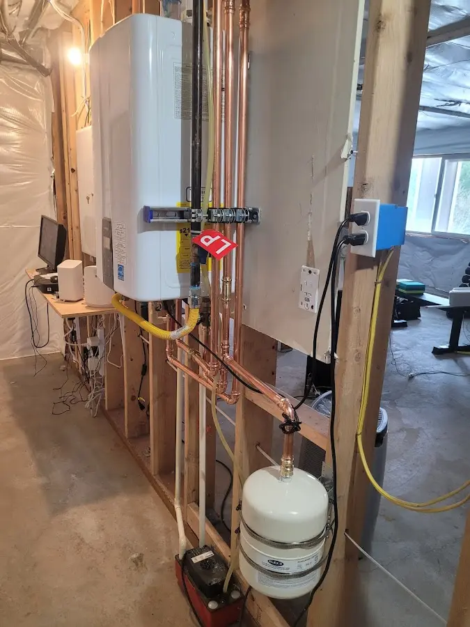 Licensed plumber repairing a kitchen sink in Lee
