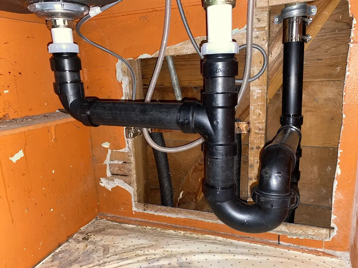Professional Garbage Disposal Repair equipment and tools on the job in Lee